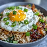 Vibrant Fermented Cabbage Kimchi Fried Rice Bowl with a sunny-side-up egg.