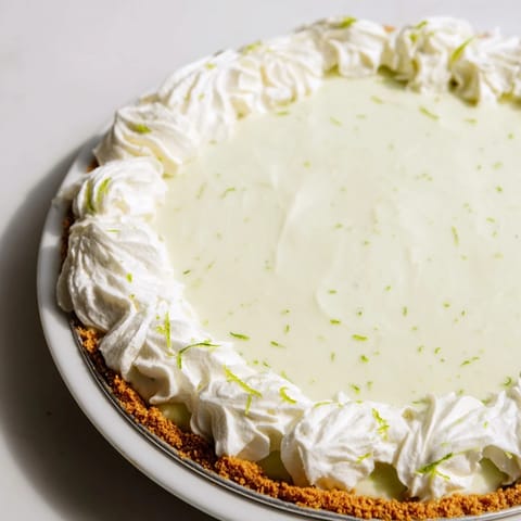 Creamy Key Lime Pie with a golden graham cracker crust, perfect for any occasion.